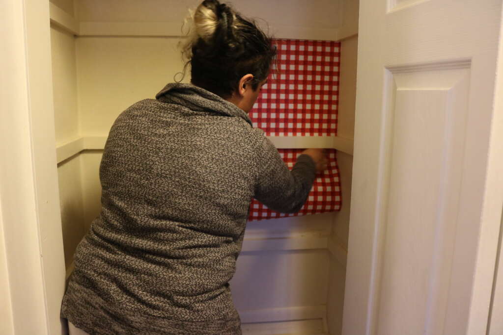 shelf liners project: applying shelf liner to wall
