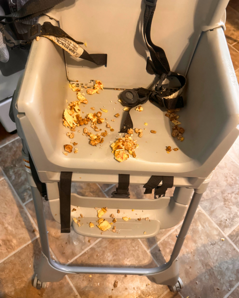 Food Waste - High chair covered in wasted food
