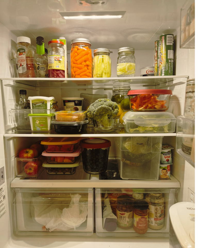 Image of inside of a fridge, with lots of fresh produce, and it is clean and organised