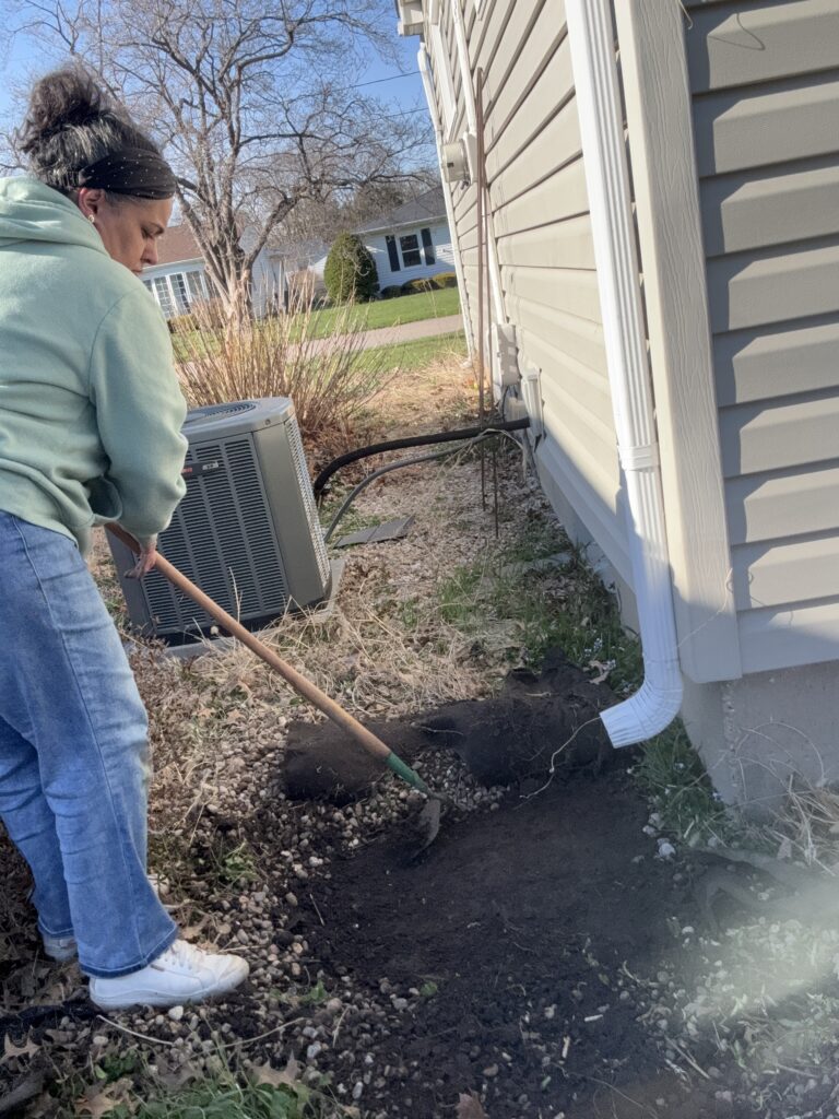 A Quick Guide to Installing a Rain Barrel - using the he to flatten the ground 1