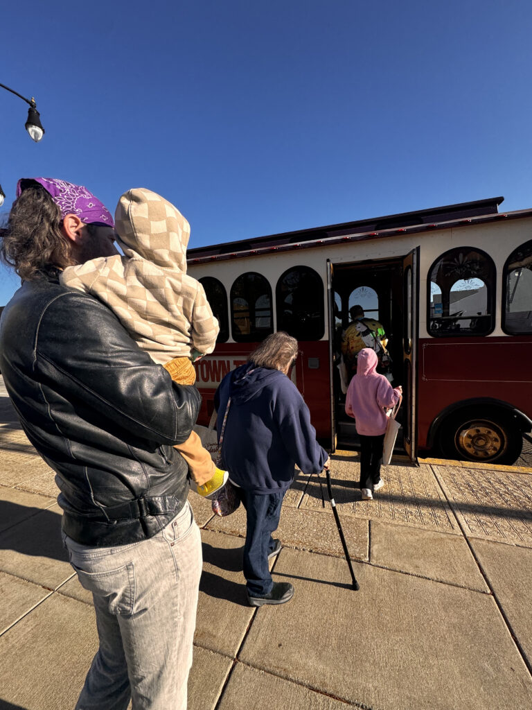 Summer rhythm - picture of people queuing to get on to an tram 