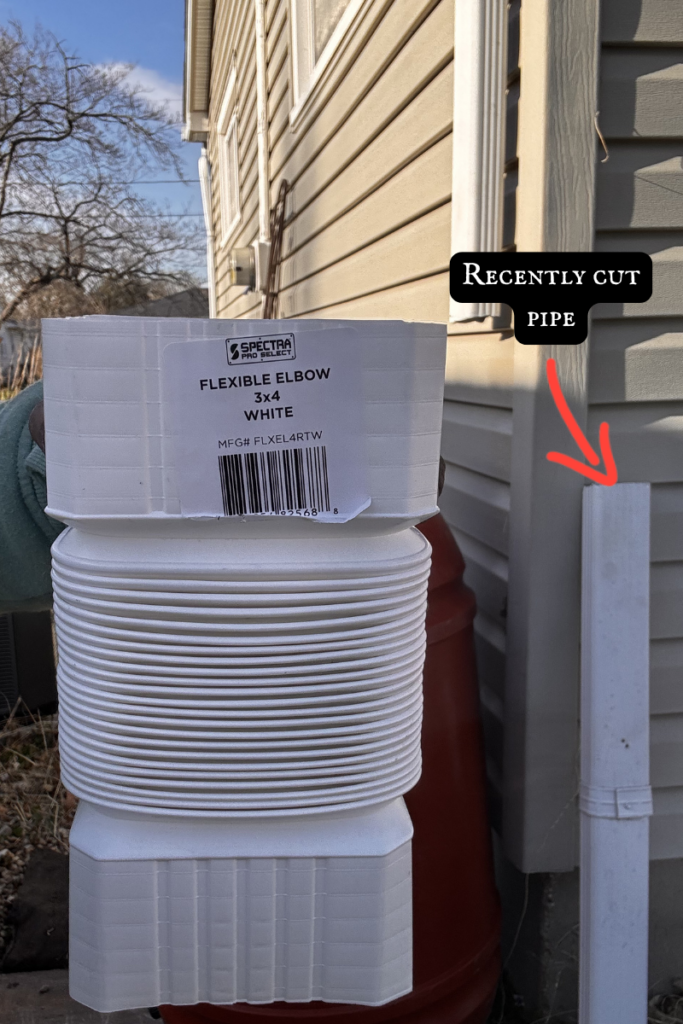 A Quick Guide to Installing a Rain Barrel - picture of flexible elbow and cut piece of downspout pipe